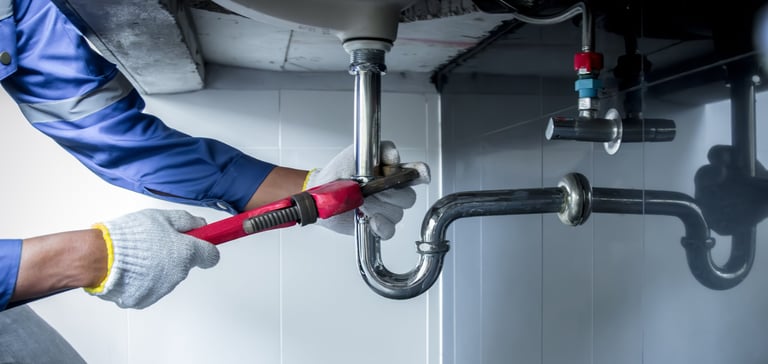 Plumber working at sink